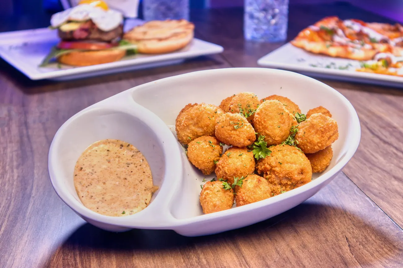 Fried appetizer bites with dipping sauce